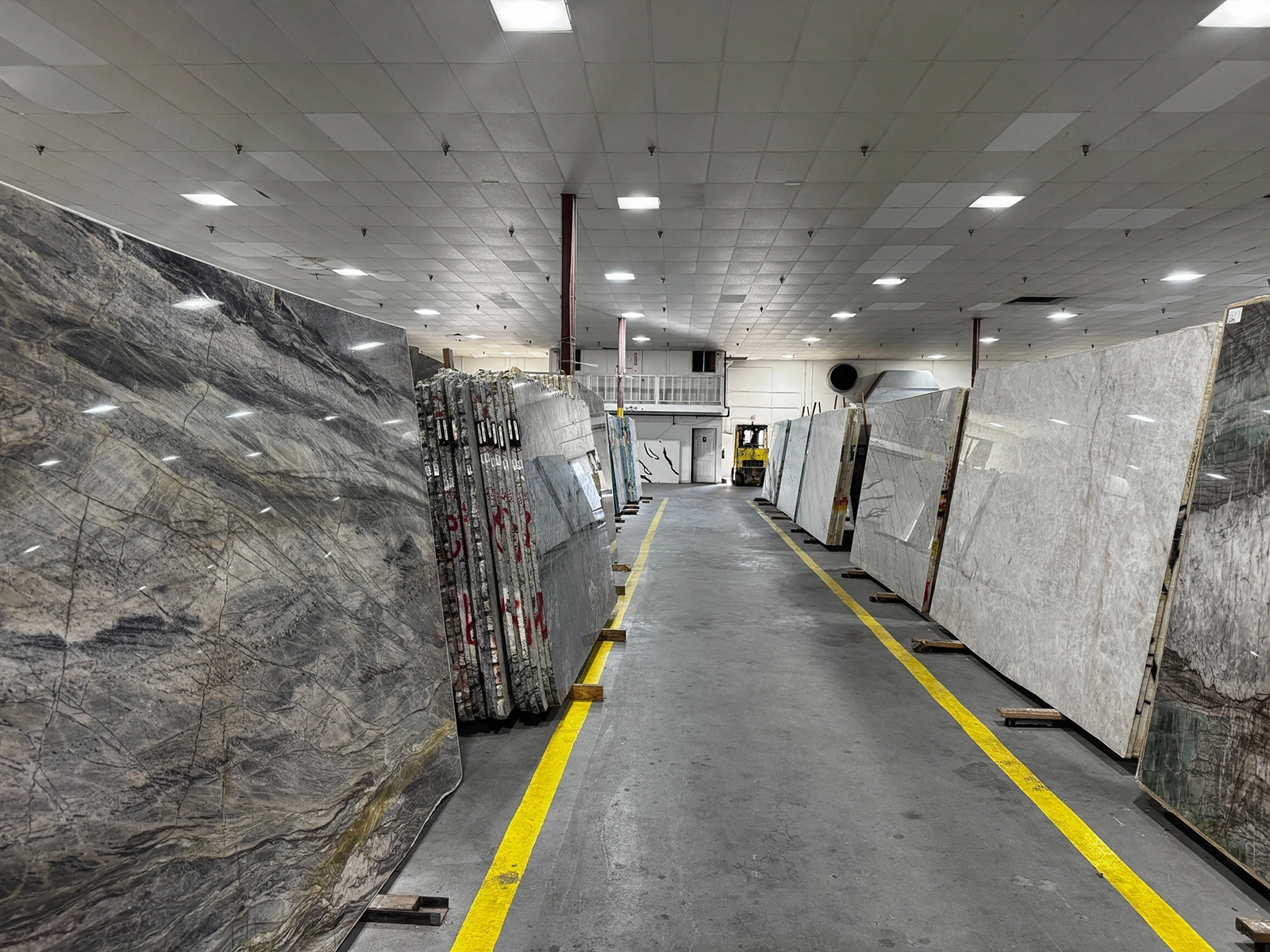 Marble slabs on display along an aisle of the AmeriQuartz warehouse in San Antonio